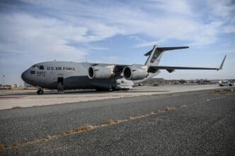 A Boeing C-17 Globemaster III military transport aircraft is parked on an airfield.
