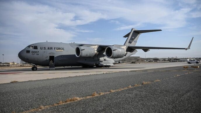 A Boeing C-17 Globemaster III military transport aircraft is parked on an airfield.