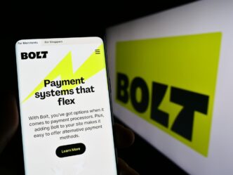 A smartphone displays the Bolt website in front of a monitor with the company's logo
