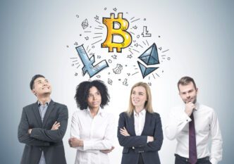 Four diverse businesspeople looking up at a drawing of a Bitcoin and other cryptocurrencies