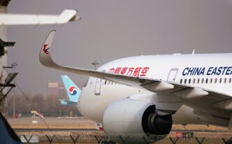 A China Eastern Airlines passenger plane is parked on an airport tarmac with another plane behind it