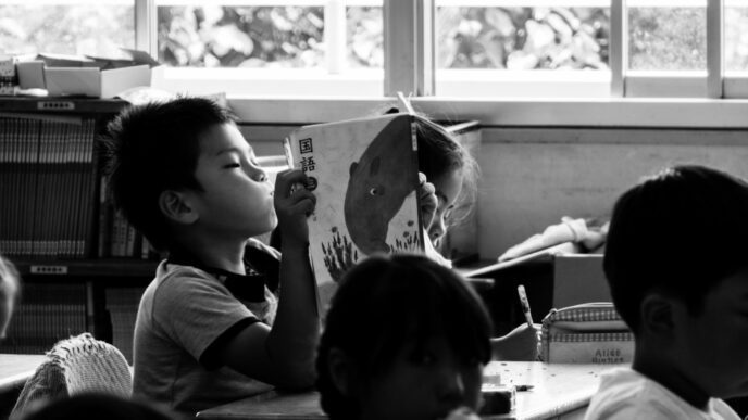 A black and white photo of Chinese children studying together in a classroom