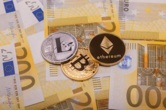Three different cryptocurrency coins, Bitcoin, Ethereum, and Litecoin, on top of Euro banknotes