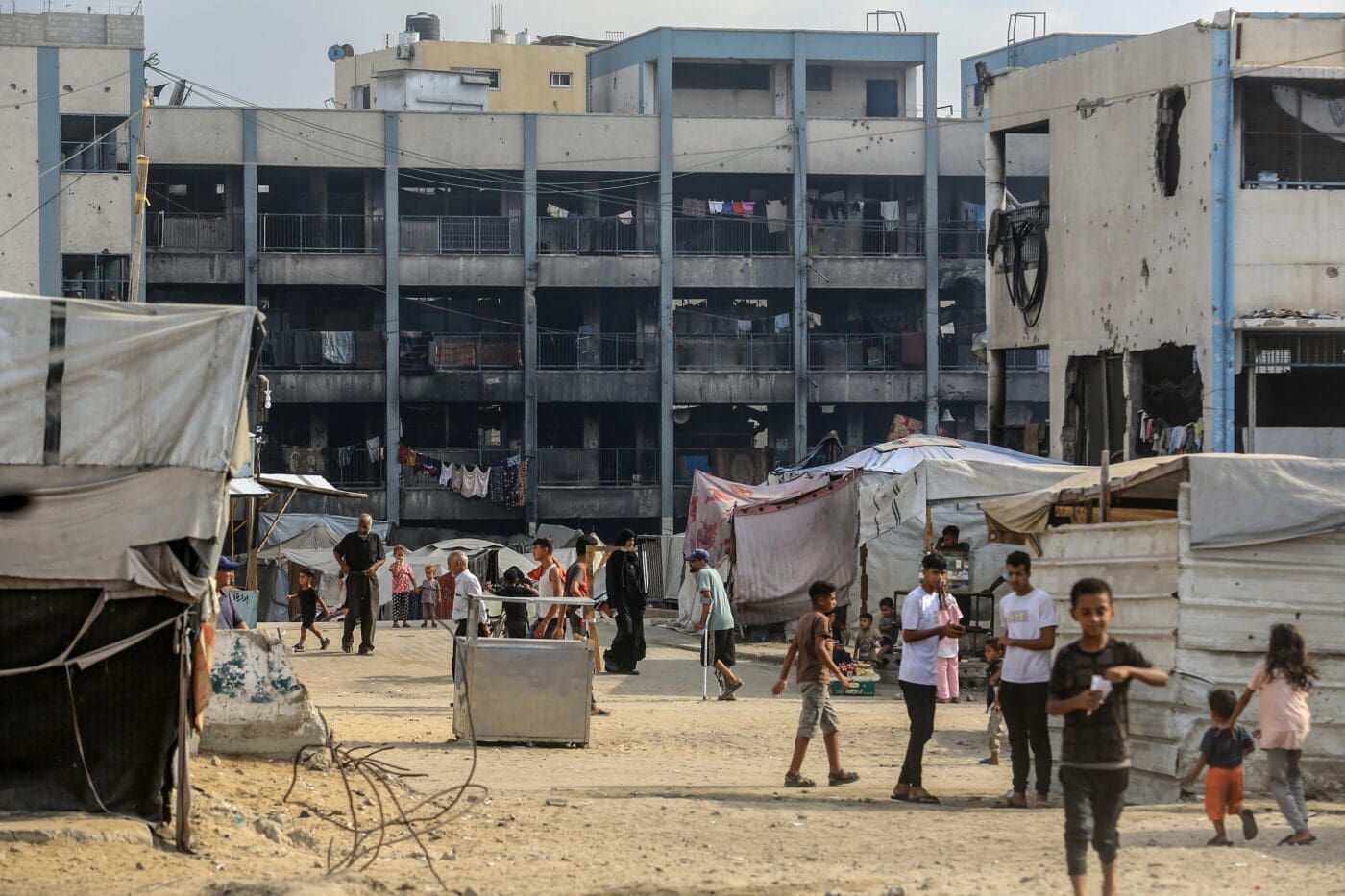 Displaced people in a damaged urban area of Gaza