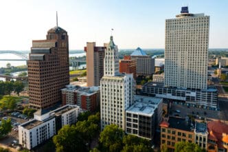 An aerial view of the Downtown Memphis, Tennessee skyline at sunset with the Mississippi River in the background