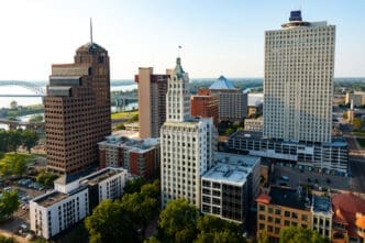 An aerial view of the Downtown Memphis, Tennessee skyline at sunset with the Mississippi River in the background