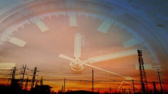 A double exposure of a clock face and a power plant at sunset, symbolizing an energy crisis