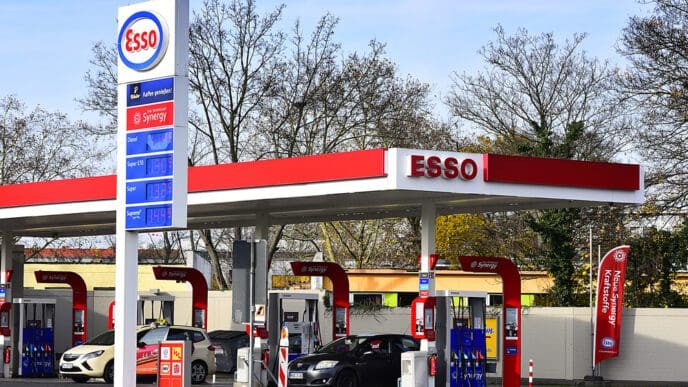 An Esso gas station with a large sign showing fuel prices in Mainz, Germany