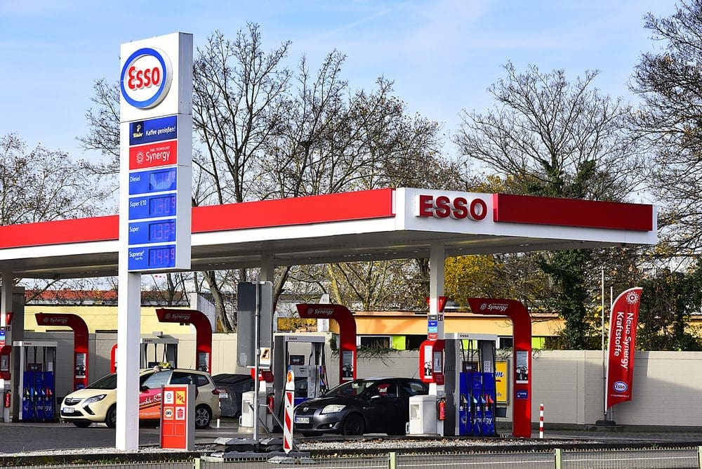 An Esso gas station with a large sign showing fuel prices in Mainz, Germany