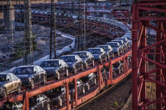 New European cars are loaded onto a long freight train for transportation and export