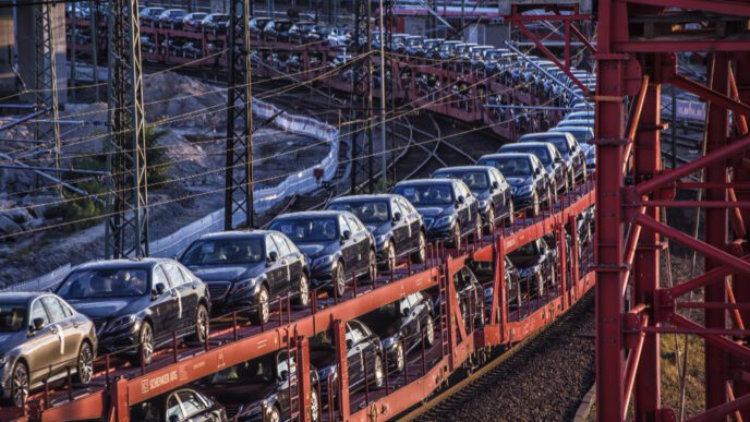 New European cars are loaded onto a long freight train for transportation and export