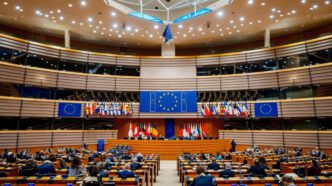 The main chamber of the European Parliament in Brussels, with delegates seated and flags displayed