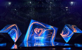 The stage of the Eurovision Song Contest with a large screen displaying the contest's logo