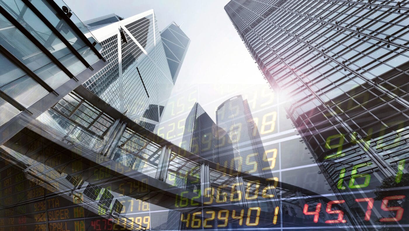 Modern skyscrapers are overlaid with stock market data