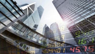 Modern skyscrapers are overlaid with stock market data