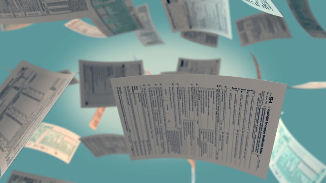 Several US tax forms are depicted floating in a stylized blue environment