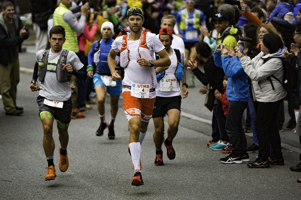 French trail runner François d'Haene jogs toward the camera with other runners behind him