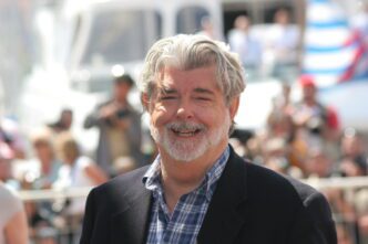George Lucas, the filmmaker, smiling and looking directly at the camera at a film festival