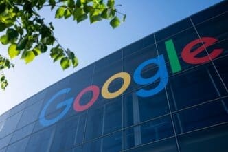 The colorful Google logo displayed on the glass facade of the Googleplex building