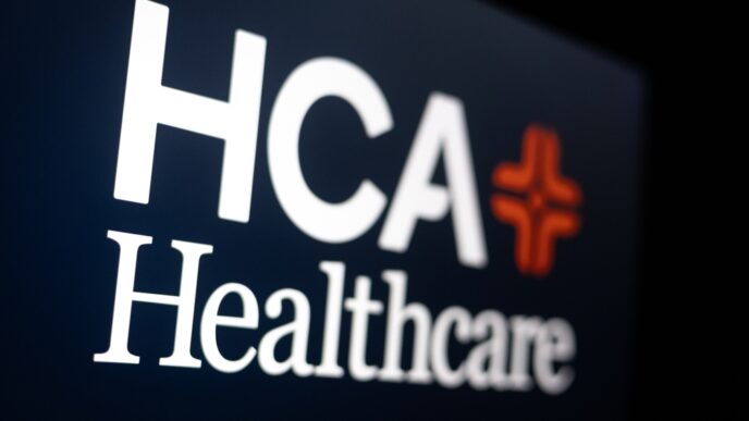 The HCA Healthcare logo with a white cross and the company name on a computer screen