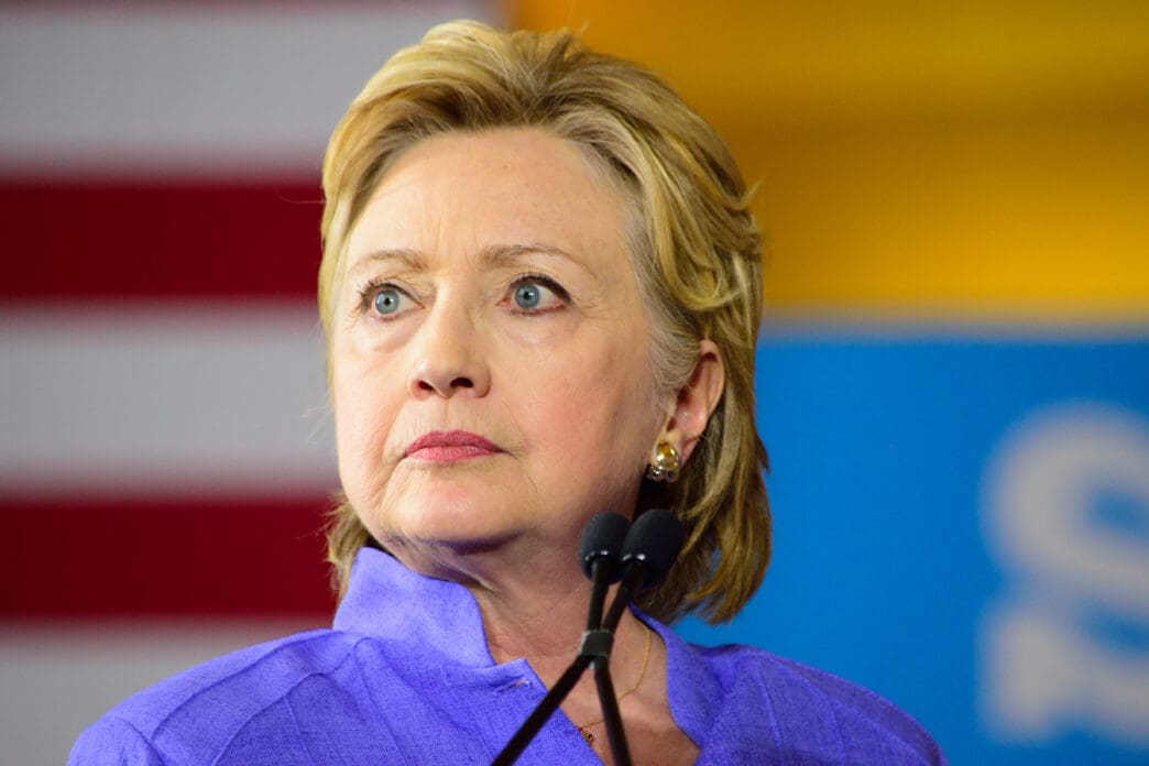 Hillary Clinton speaks at a campaign event with a pensive expression