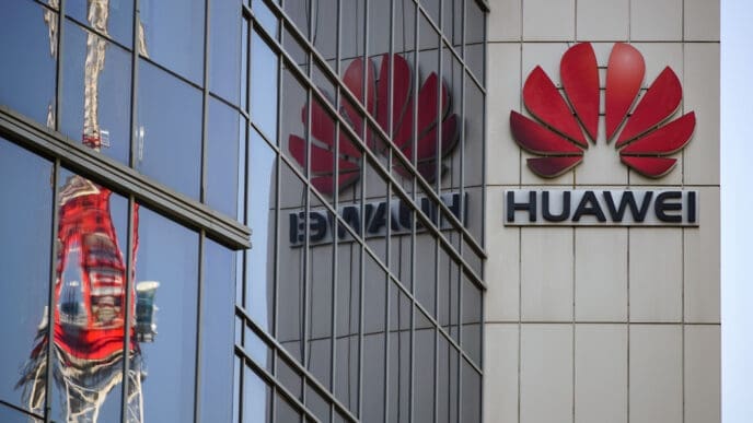 The red Huawei logo is displayed on the facade of a large building