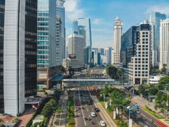 Busy street scene in Jakarta, Indonesia, with modern skyscrapers and traffic