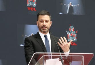 Jimmy Kimmel speaks at a podium at the TCL Chinese Theatre event