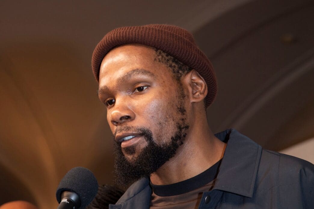 Kevin Durant, a professional basketball player, speaking into a microphone at a premiere event