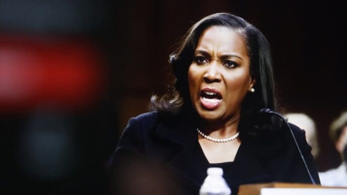 American economist Lisa Cook speaks passionately into a microphone at a formal event