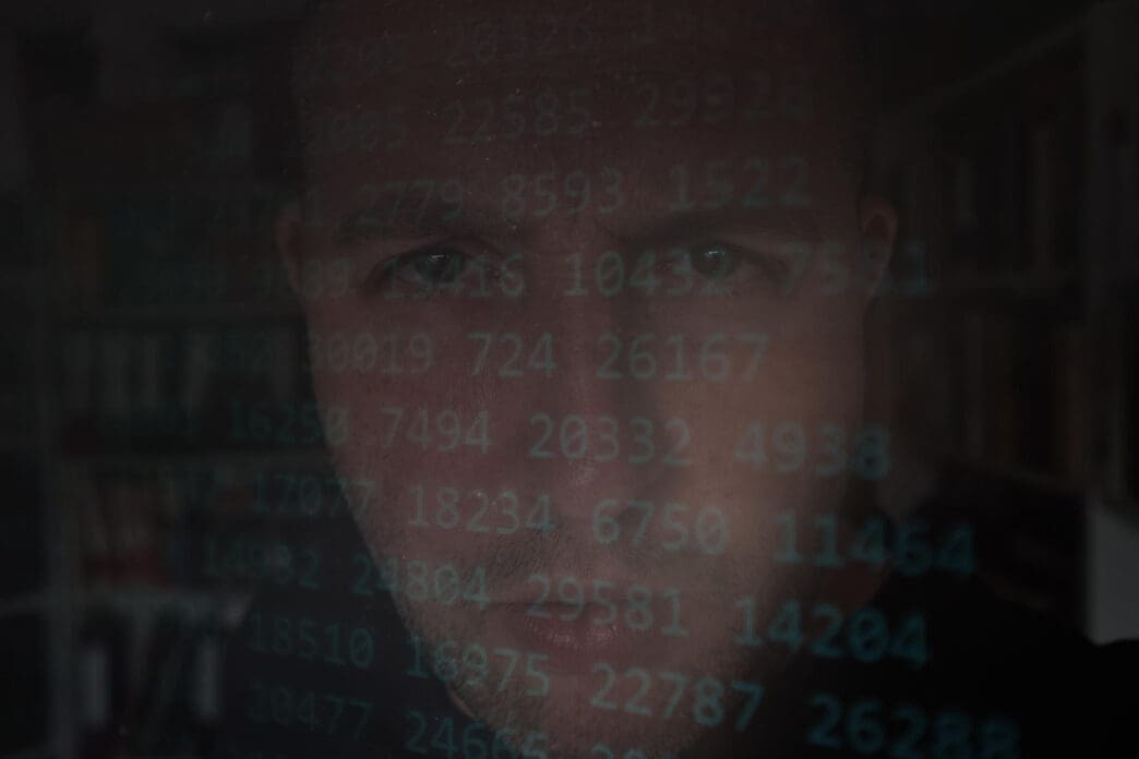 A man in a mail carrier uniform puts envelopes into a red bag with a barcode, representing a concept of mail and identity fraud