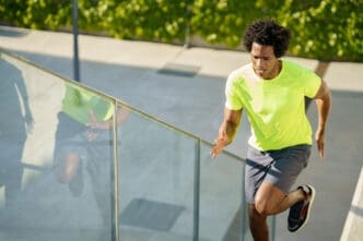 Man running up stairs outdoors in bright athletic wear
