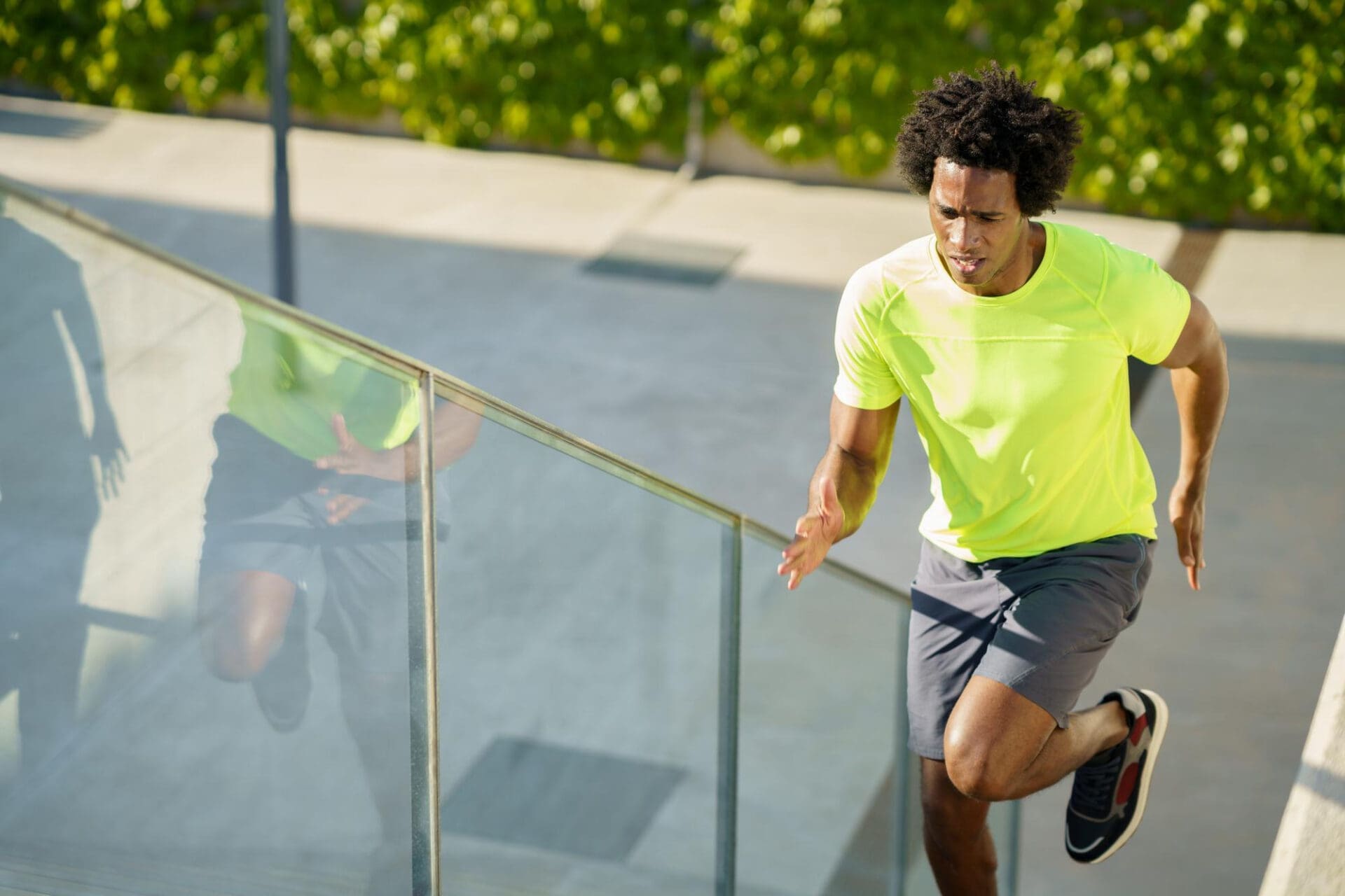 Man running up stairs outdoors in bright athletic wear