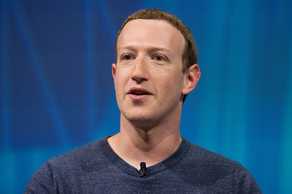 Mark Zuckerberg, the CEO of Facebook, speaks at a press conference against a blue background