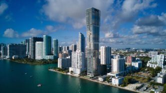The modern Miami skyline of the Edgewater district is seen from the water on a sunny day