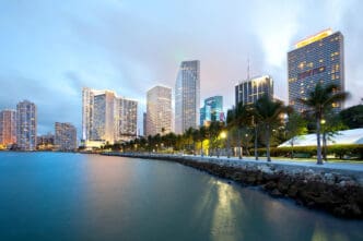 Downtown Miami skyline at dusk with palm trees and waterfront