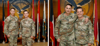 Two US Army officers pose for a photo with medals displayed