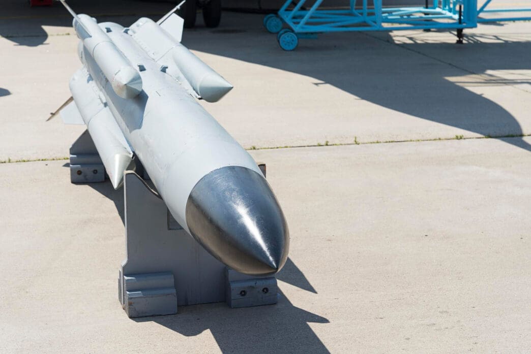 A detailed view of a gray military missile on display.