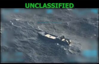 A screengrab from a military surveillance video of a small boat on the open ocean