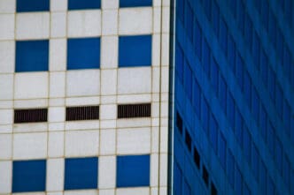 Close-up of modern building facades with white and blue square windows