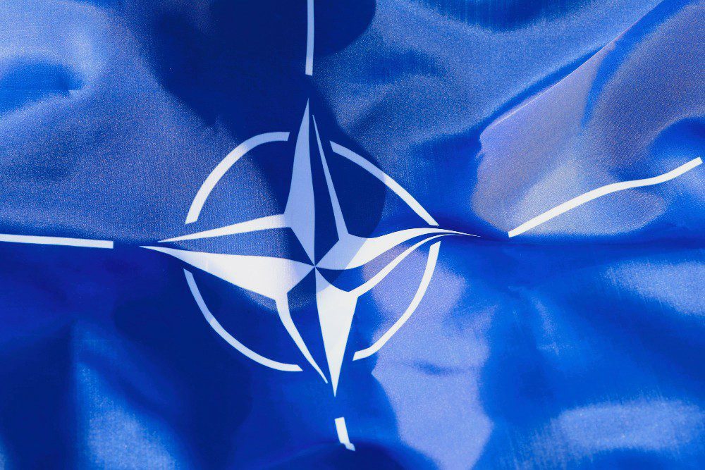 The blue and white flag of the North Atlantic Treaty Organization (NATO)