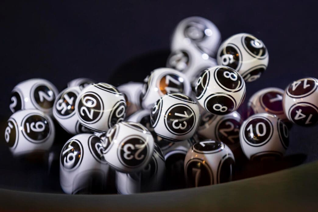 Close-up of numbered bingo balls in a dark setting