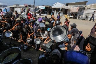 Palestinians receiving hot meals from a charity kitchen in Gaza