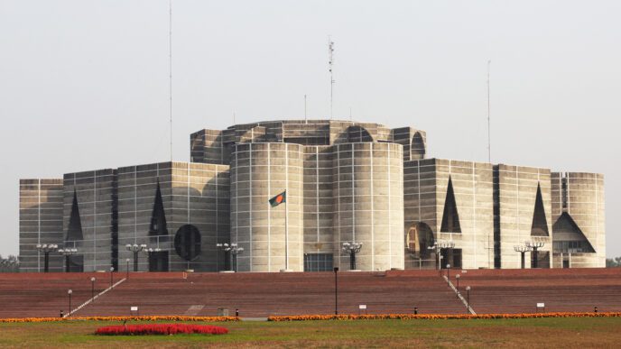 The National Parliament House of Bangladesh, a large, modern concrete building with a flag