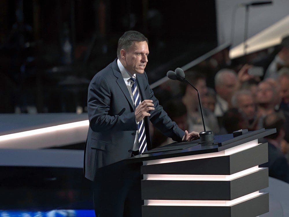 Peter Thiel speaks at a podium with two microphones during a political convention