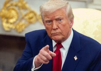 Donald Trump points forward while meeting with Benjamin Netanyahu