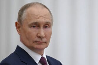 A head-and-shoulders portrait of Russian President Vladimir Putin, who is looking at the camera with a serious expression