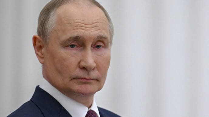 A head-and-shoulders portrait of Russian President Vladimir Putin, who is looking at the camera with a serious expression