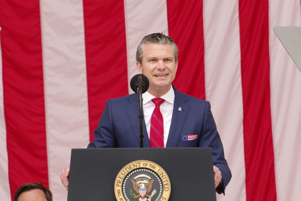 Secretary of Defense Peter Hegseth speaks at a podium with the Presidential Seal