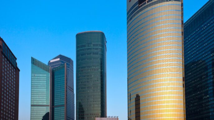 Modern skyscrapers and corporate buildings in Shanghai's Lujiazui financial district under a blue sky